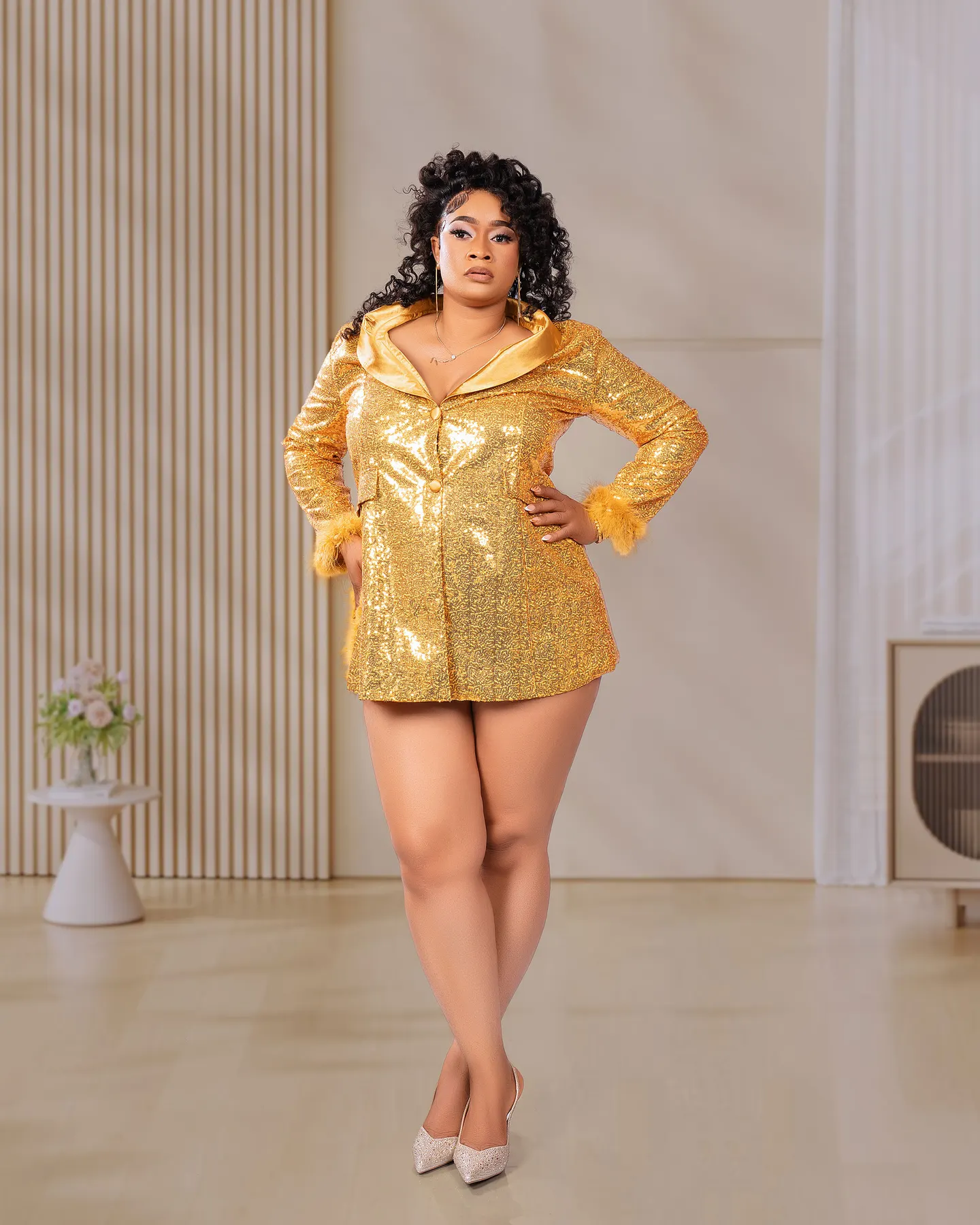 Studio portrait in a gold sequin blazer dress
